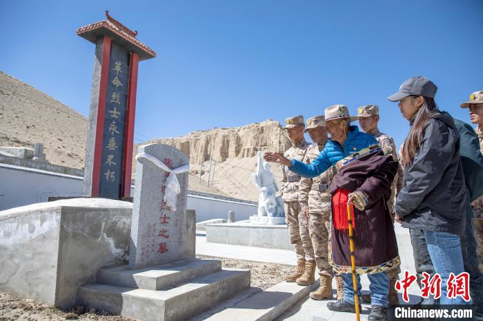 圖為在西藏阿里地區(qū)札達縣烈士陵園，82歲的次仁南杰老人為軍民代表講述新舊西藏的變化?！詵| 攝