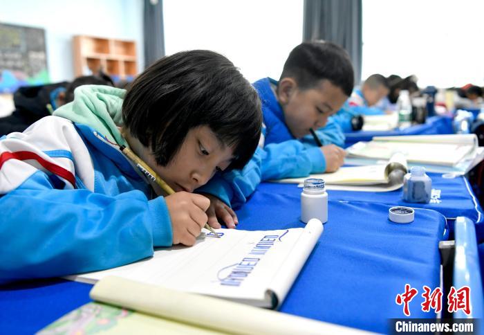 3月14日，西藏拉薩市第一小學一年級六班的學生們在藏語文課上書寫藏文?！±盍?攝